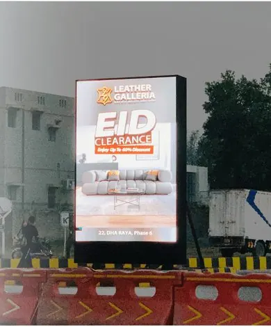 SMD sign-pole screen showing an Eid sale at DHA Raya, Phase 6, Lahore